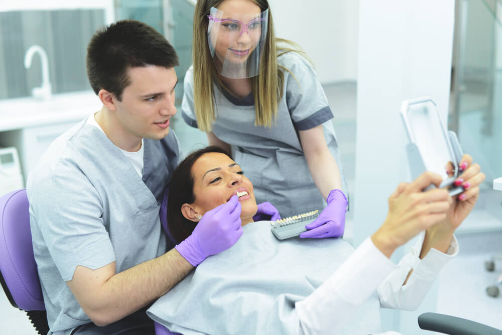Dentists and patient during shade matching