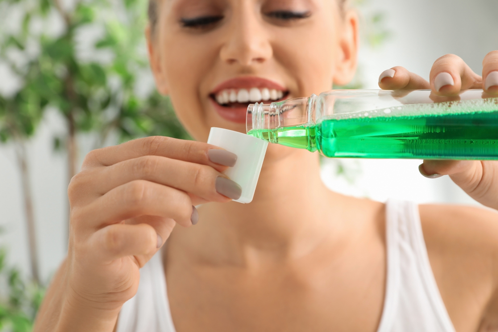 Woman pouring a mouthwash serving