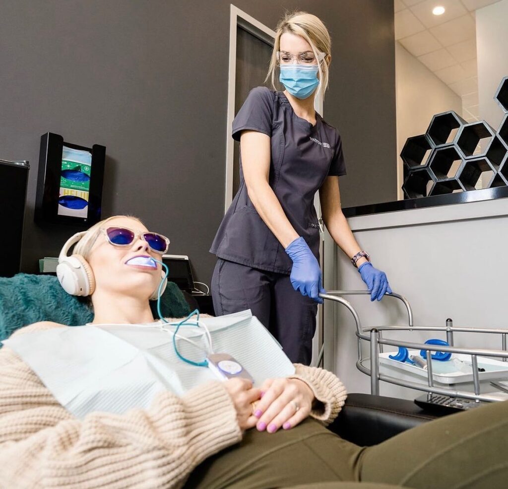 Patient relaxing with headphones on while receiving a teeth whitening treatment at Toothbar, enjoying a soothing, multimedia dental experience.
