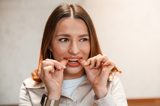 Patient putting clear aligners on in office.