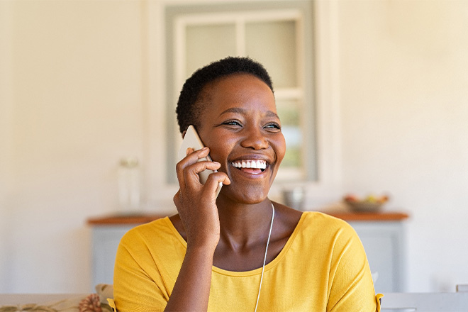 Woman smiling while talking on phone.